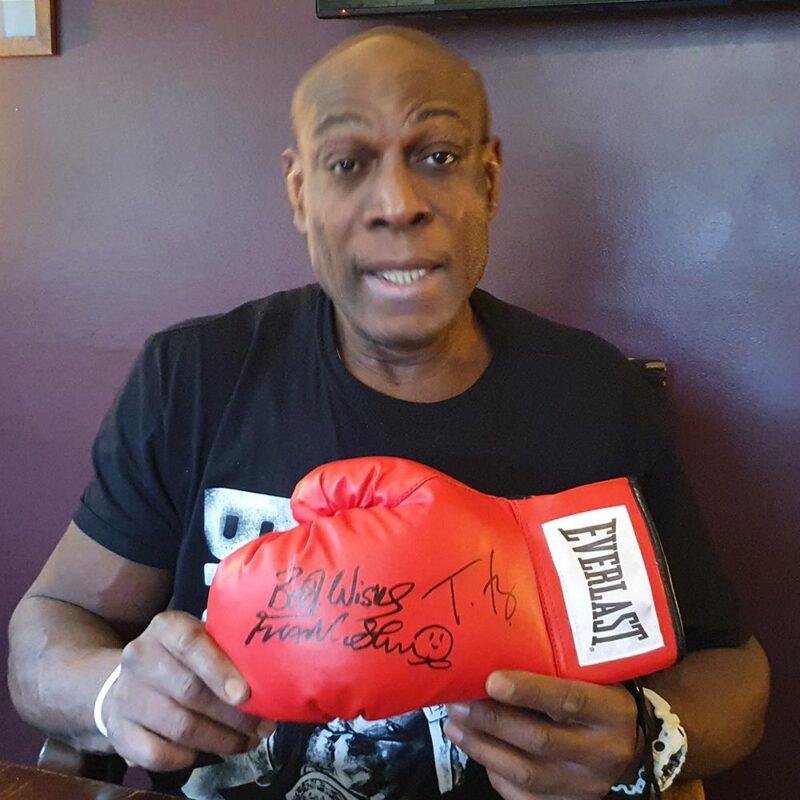 Frank Bruno signing a glove