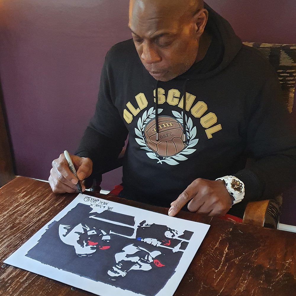 Frank signing the coloured gloves print