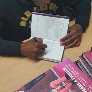 Frank signing a book 2022